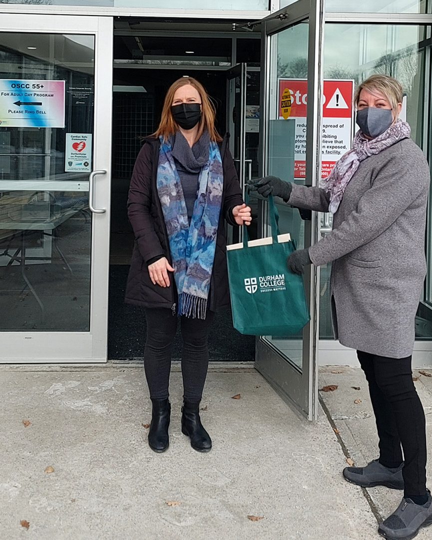 Kimberlee Neault (right), DC PSW professor delivering the student's handmade cards and letters to Misty Mazza (left), Northview Adult Day Program Supervisor to be given to older isolated adults.