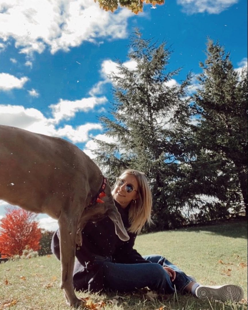 Mikayla Young, owner of Mik's Makings outside with her dog on a break from making jewelry.