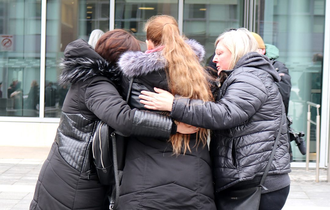 Supporters hug Krysia Meeldyk, Rory Hache’s godmother, after she addressed reporters.