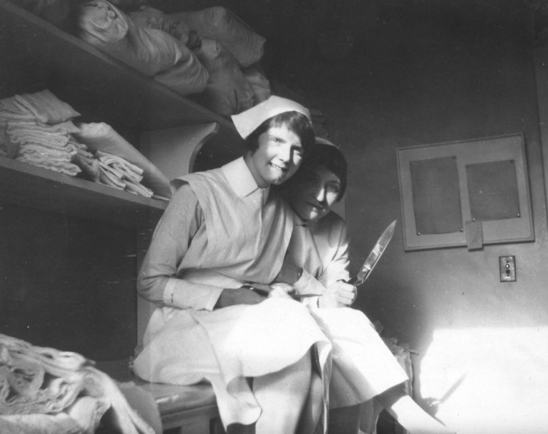 Two nursing students, Miss McCohn and Miss Hutchison, making dressings in the surgical wing of the hospital.