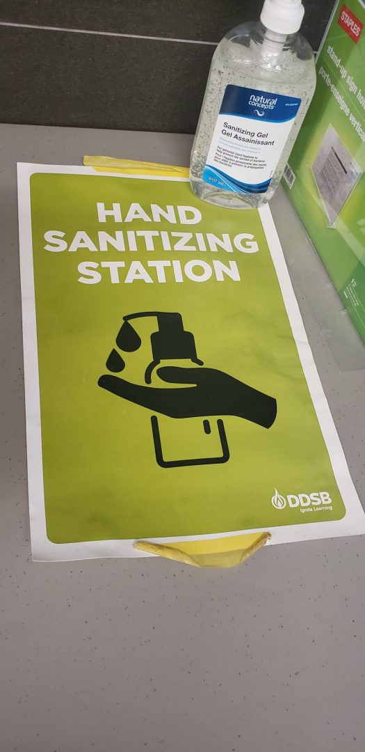 A sign showing people where a hand-sanitizing