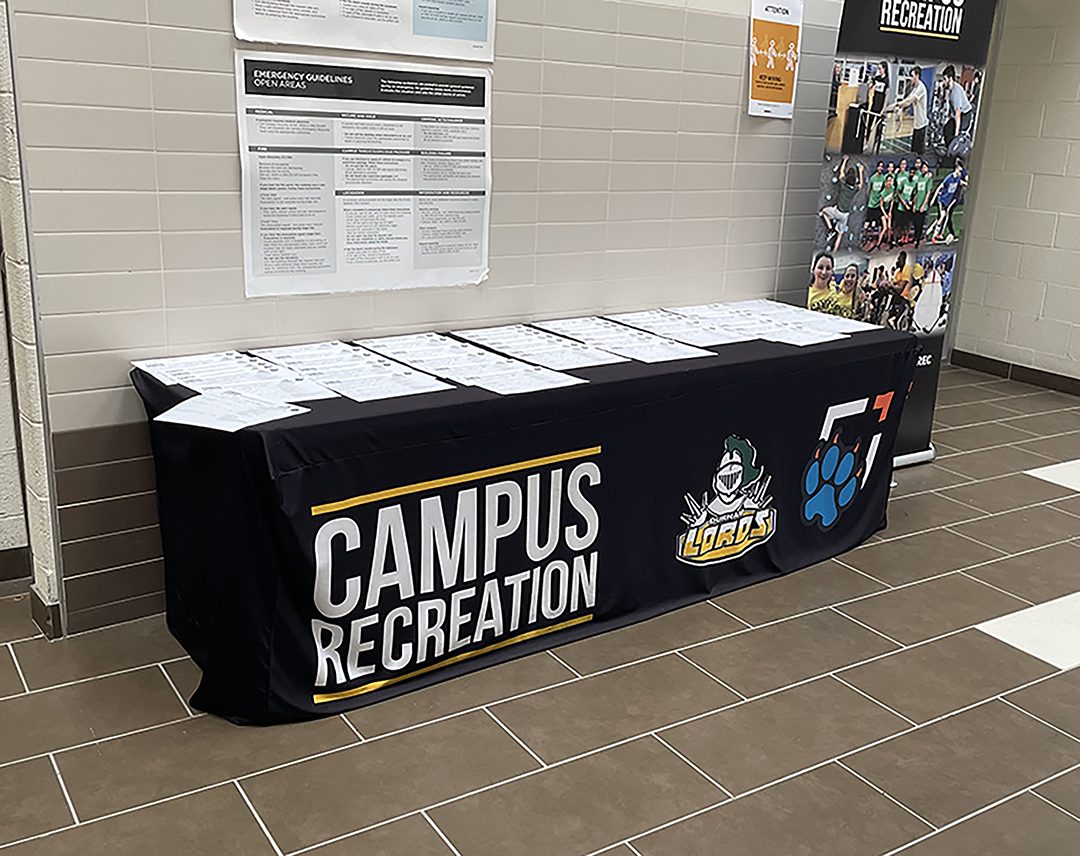 Sign up desk for intramurals at the entrance of the campus gym.