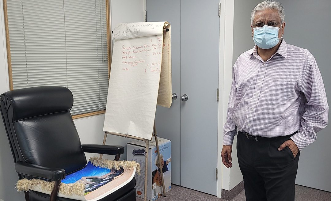 The President & General Manager at Scarsview Chrysler, Sudhir Chopra, is in his office.