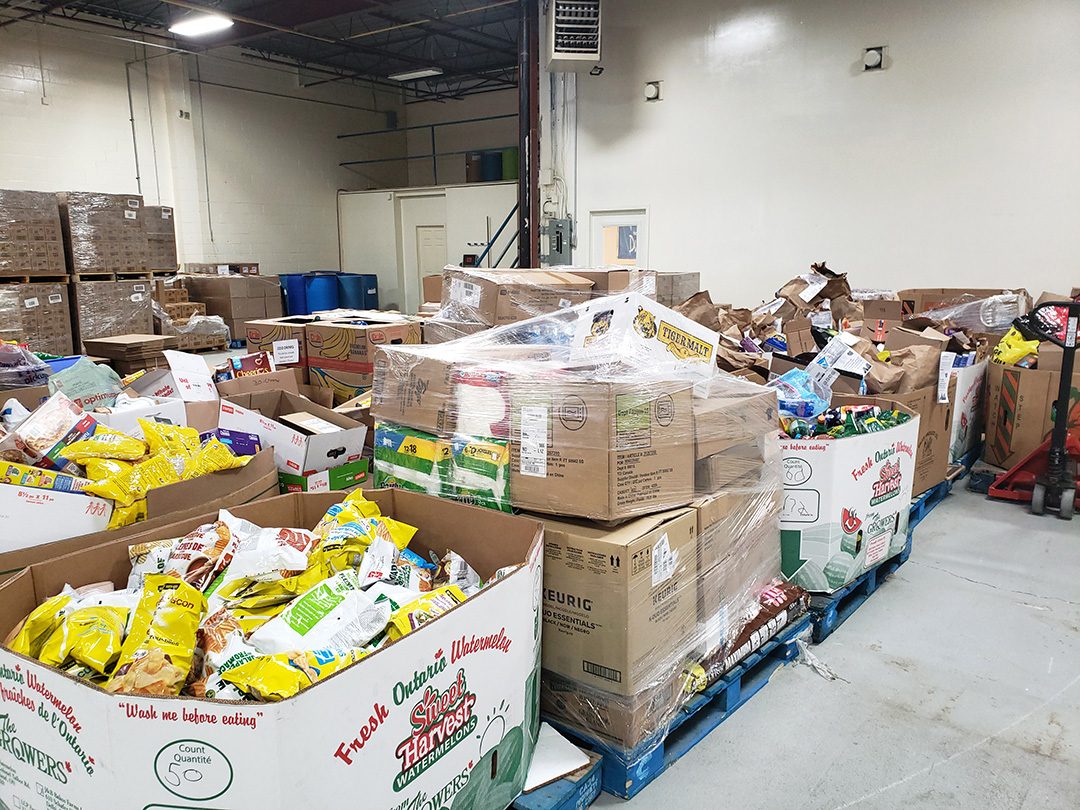 Hundred of pounds of food are donated to Feed the Need and transported to warehouses such as this one located in oshawa. These pallets are donation from a food drive.