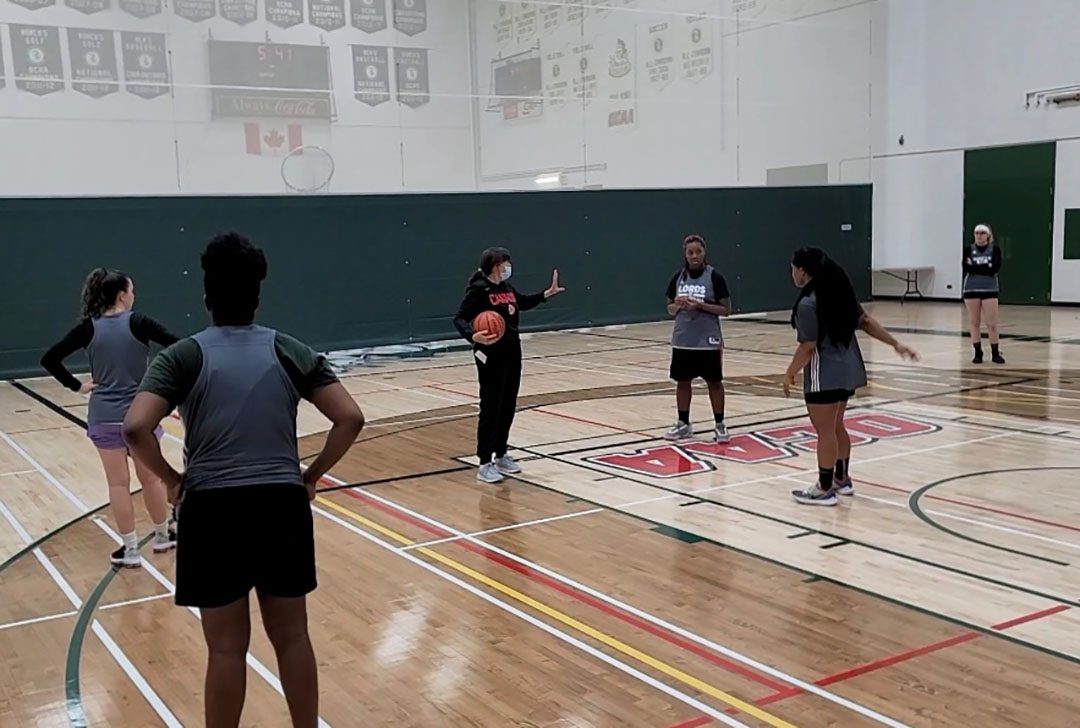Heather LaFontaine, who has been the head coach since 2013 of the Durham College Women's basketball team, gives  instruction for the team. This part of the practice, she is teaching how to keep the ball.