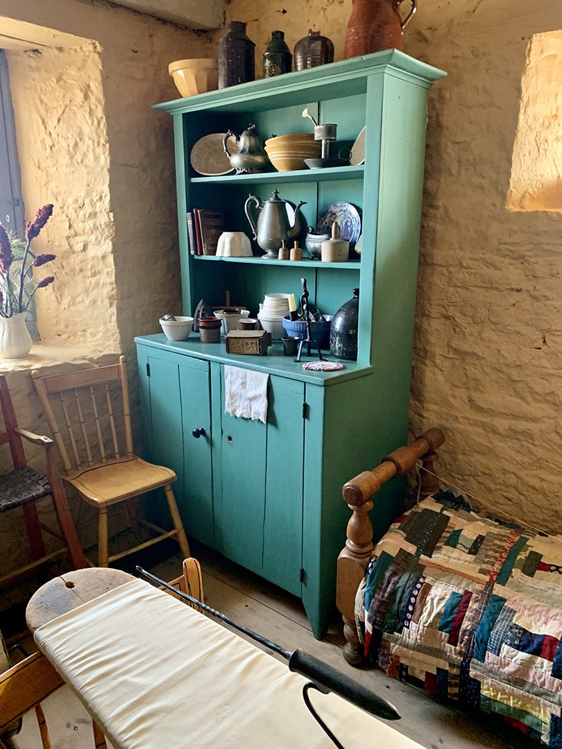 A kitchen hutch in the corner of the keeping room restored to its orginal colour.