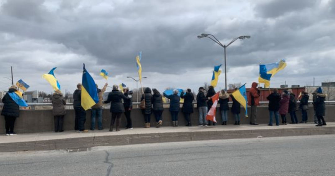 Supporters flank the bridge across Highway 401 encouraging drivers to show their support for Ukraine.