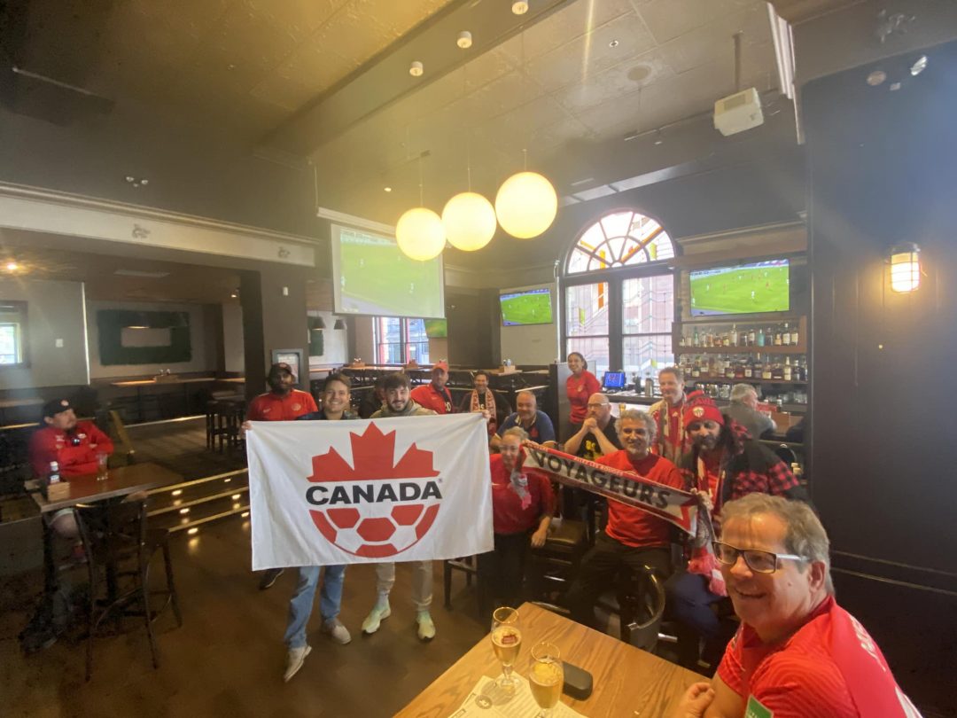 Fans watching Canada's 2-0 win over Qatar in preparation for the tournament at a local bar.