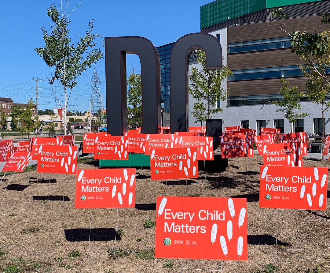 Durham College displays 94 Every Child Matters signs, one for each of TRC's calls to action.
