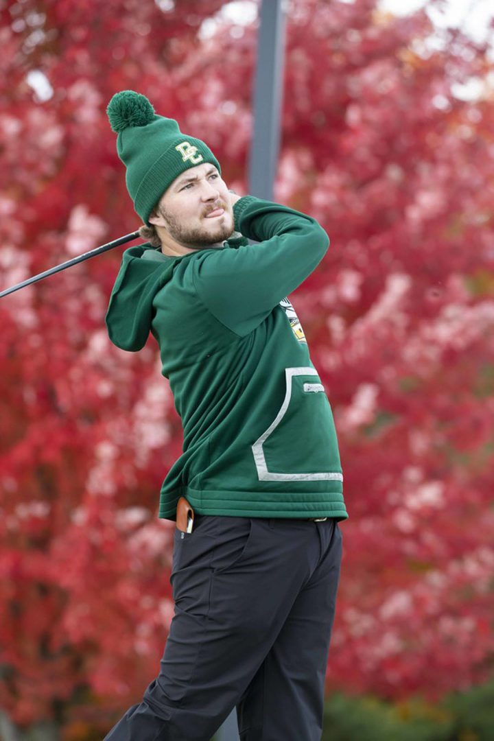 10/19/2022 - Cam Lyon of the Lords' golf team watching his tee shot on the first hole at Deer Creek Golf Club in Ajax