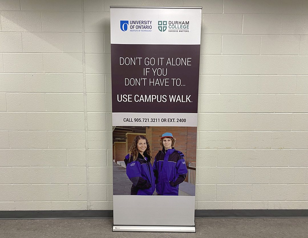 The Campus Walk program is advertised at Durham College. Contact information is shown on the sign.