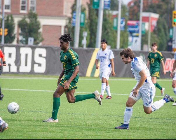 Nguewo running down the middle of the pitch for the Durham Lords at Vaso's field.