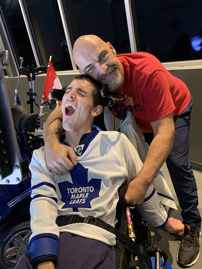 Marshall Hohmann and his caregiver Shawn Buteau spending time together at a Toronto Maple Leafs Game.