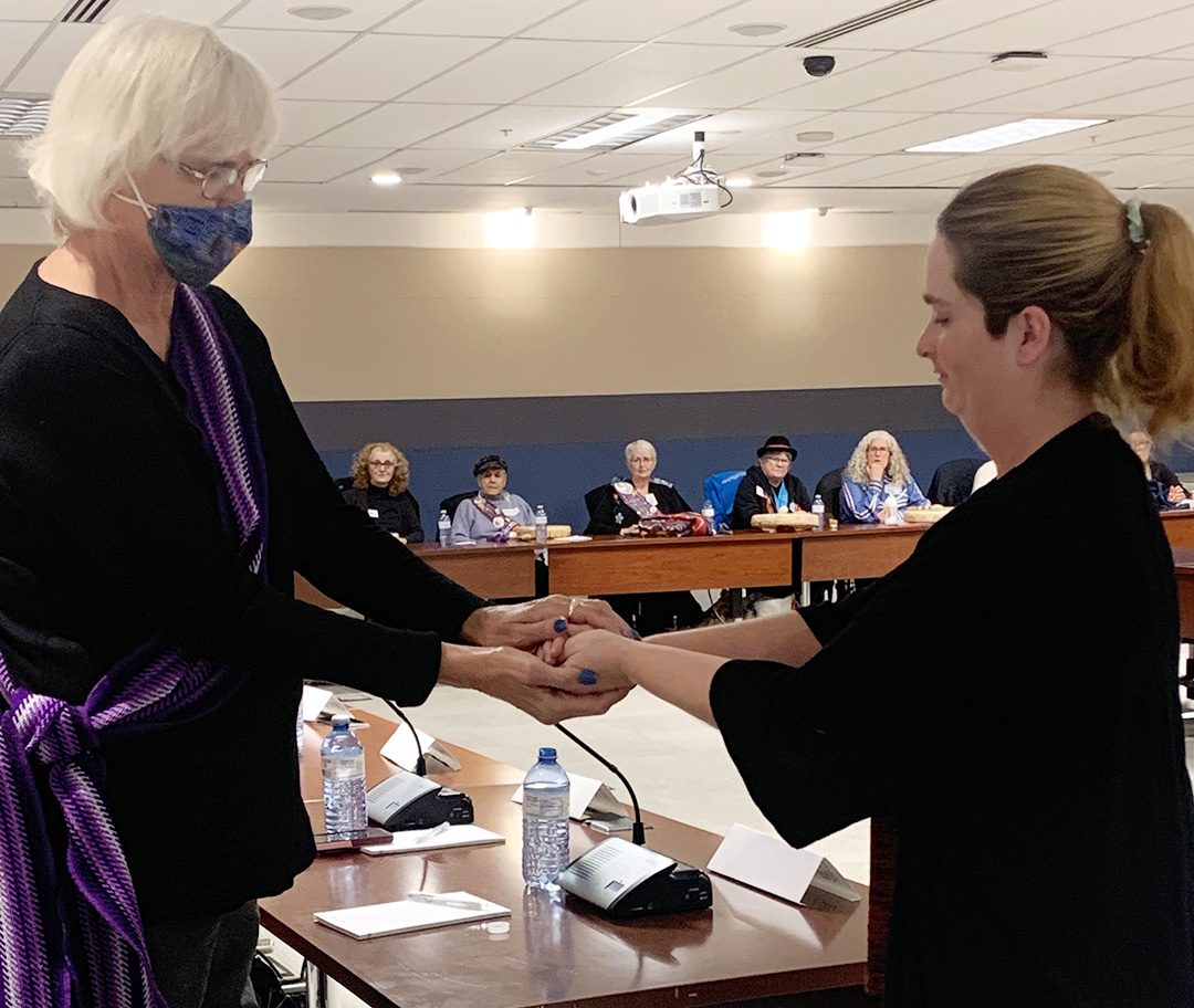 First-year journalism student Stephanie Readman presents councillor and elder for the Oshawa and Durham Region Métis Council Pearl Gabona with a tobacco tie at the 'Voices in Durham' community listening event.