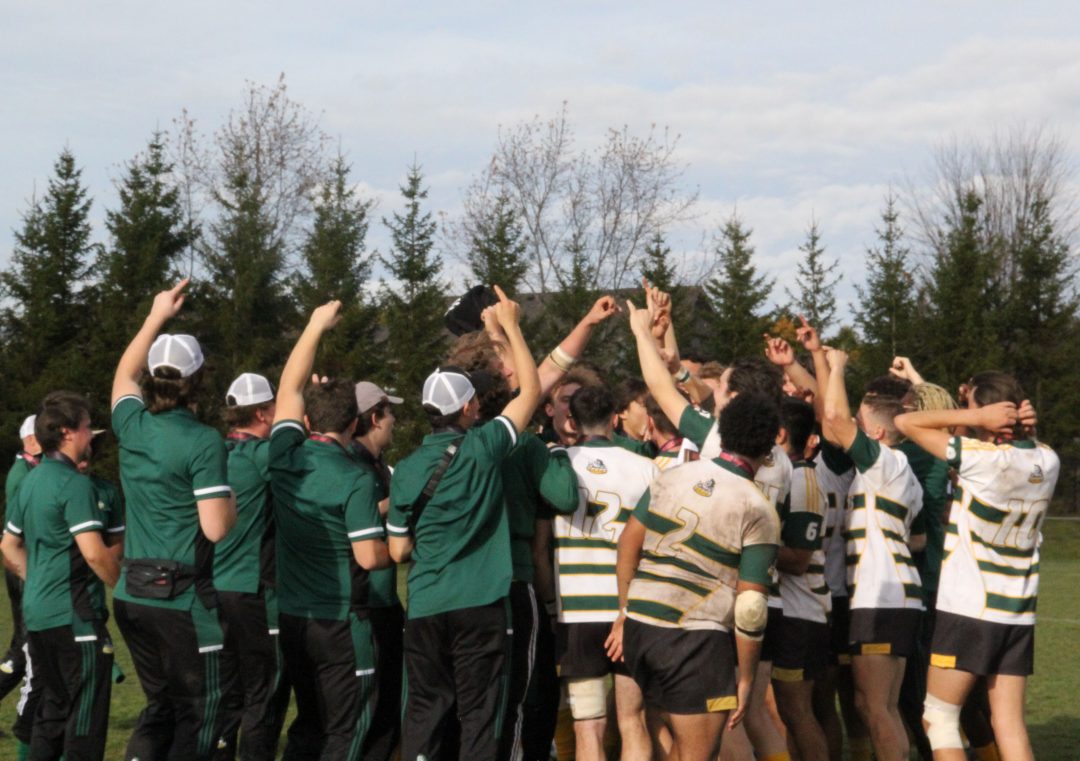 The coaches and players gathered in a small huddle at Thompson Park to celebrate their win together.