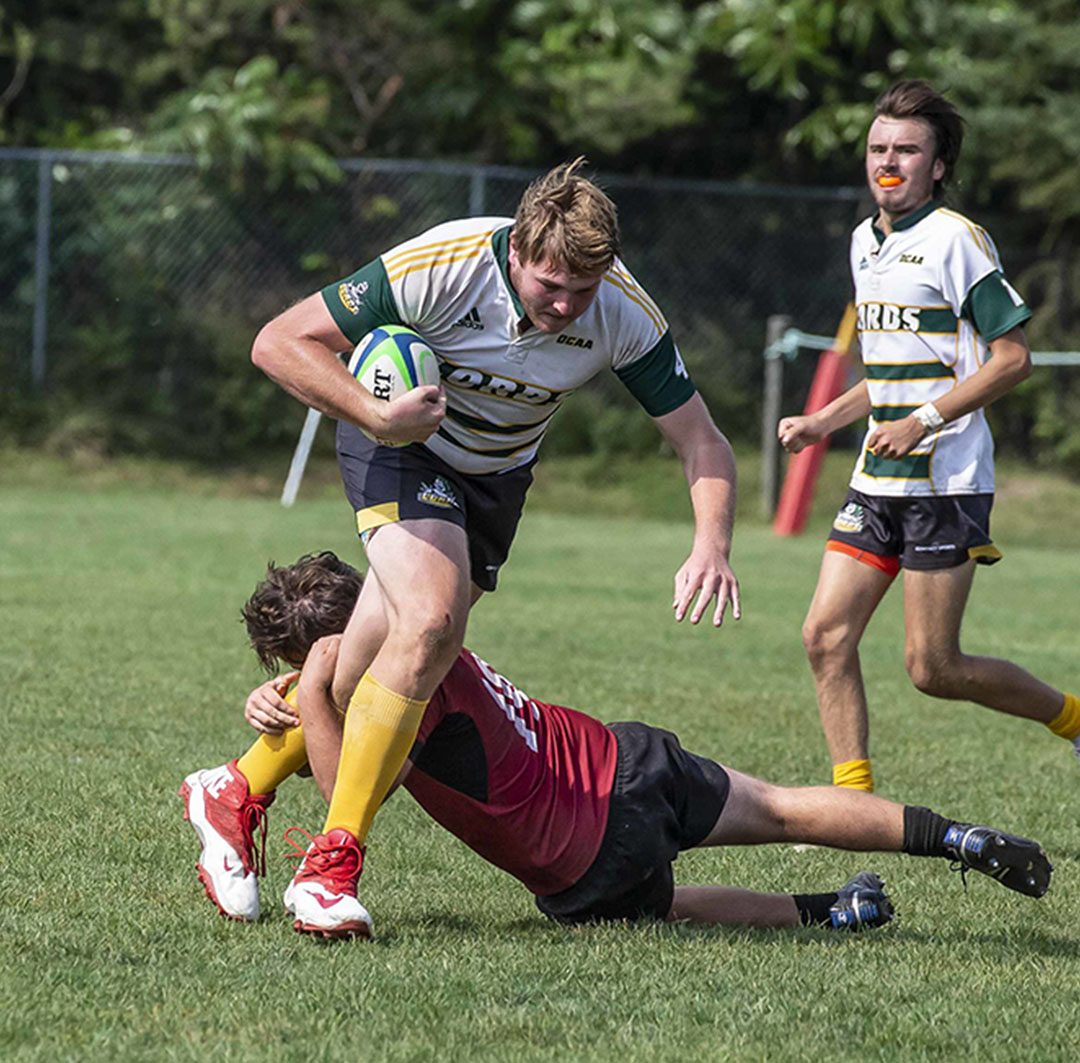 Lords' second row, Devon Parson (centre) avoiding a tackle with the ball in his right hand in a game against St. Lawrence.