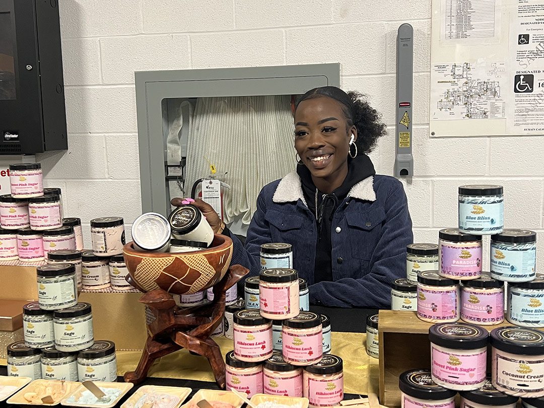 Jan'na Tchadouwa posing with her Shea Shimmers products at the holiday market.