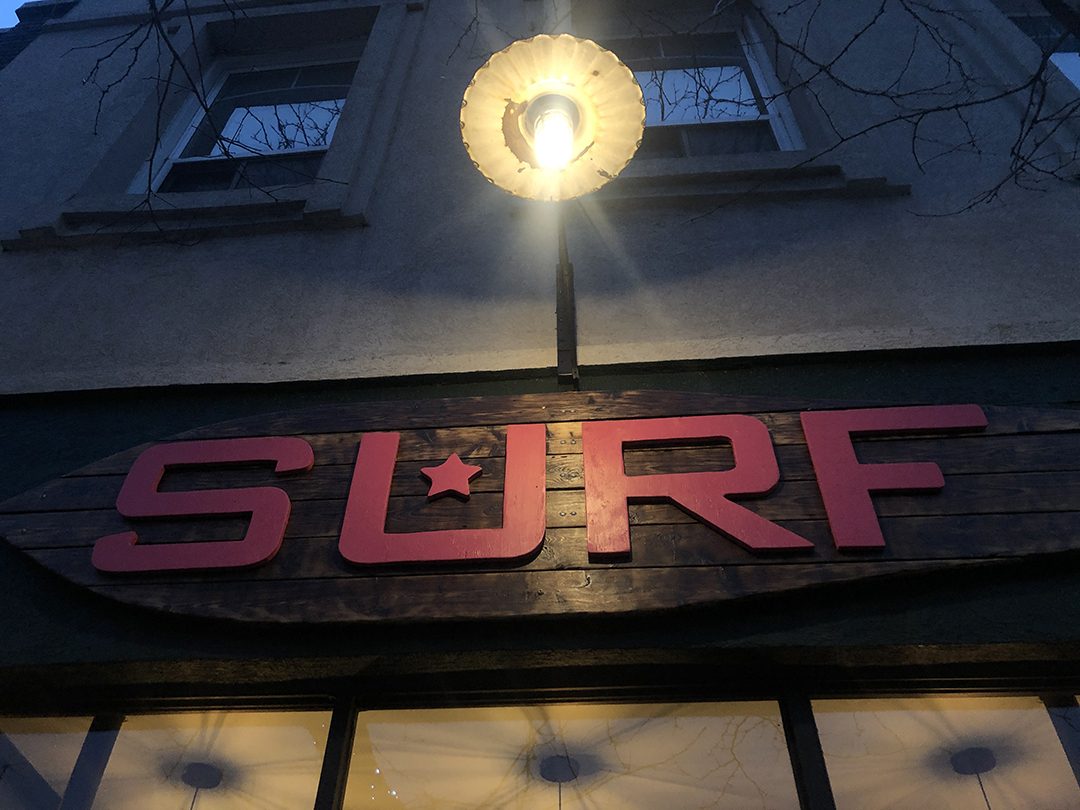 The outside sign of Surf restaruant in downtown Whitby.