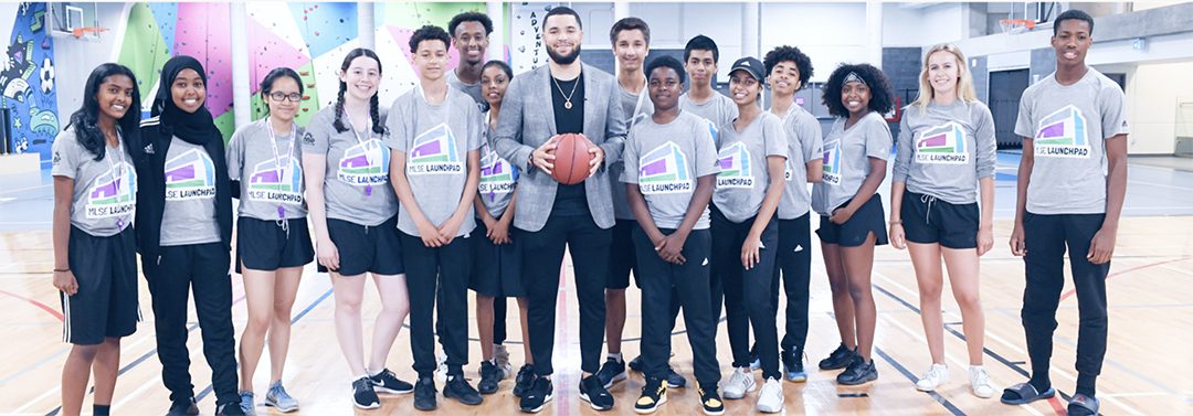 Fred VanVleet of the Toronto Raptors and participants at the MLSE LaunchPad posing for a group photo.