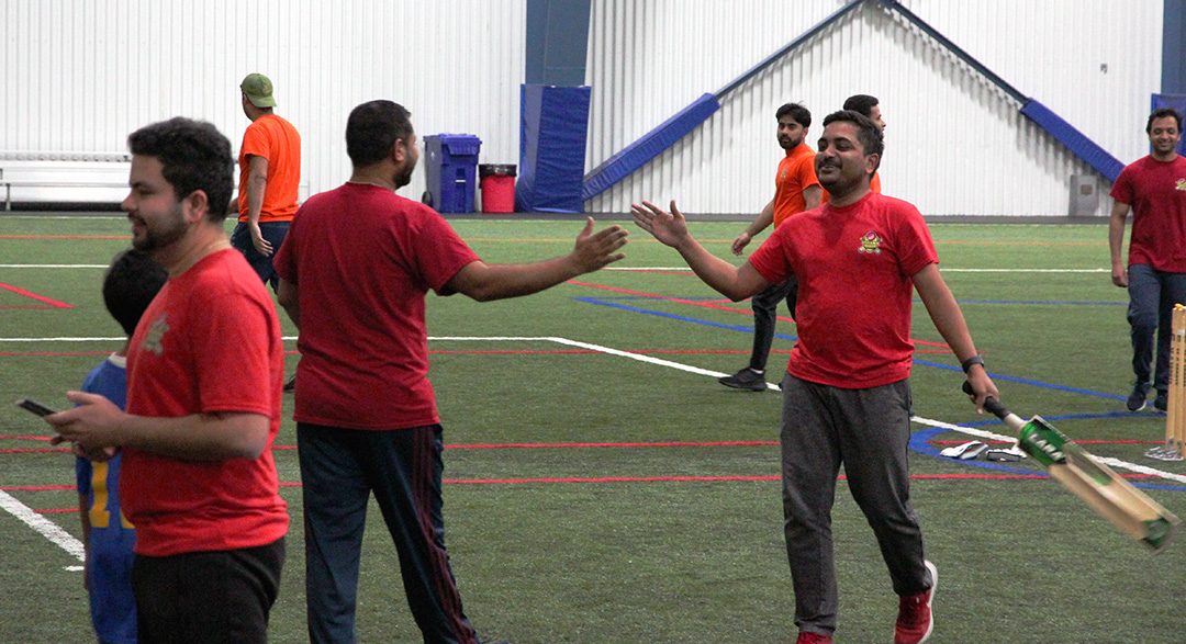 Team Red members celebrate after coming out on top after an over (similar to an inning). Team Red is part of the Oshawa Cricket League and currently sit third in the league. The matches take place at 9 p.m. every week at the Oshawa Civic Recreation Complex.