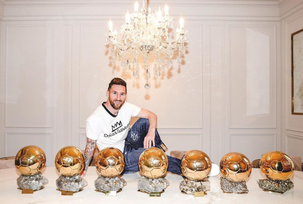 Lionel Messi posing on his kitchen table at home after winning his seventh Ballon D'or.