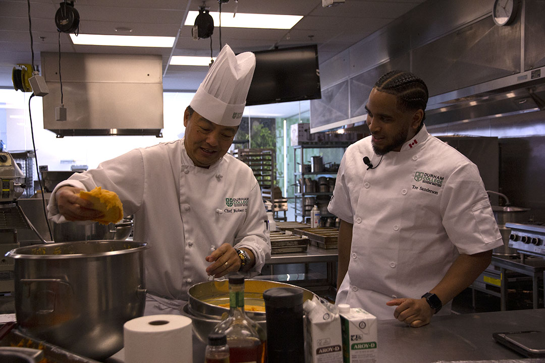 Tre Sanderson reunites with former culinary instructor Robert Chin. Chin is proud of Sanderson's Top Chef win and saw talent in him from the beginning.