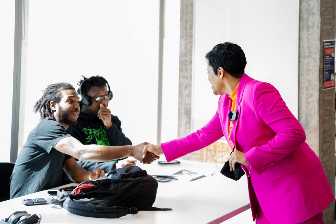 Ackheele Angus, 20, (left), and Tolu James, 19 (second from left), meet Minister Ien (right) during her tour of Ontario Tech. Ien connected with the students about Scarborough life as they took a break from studying for exams.