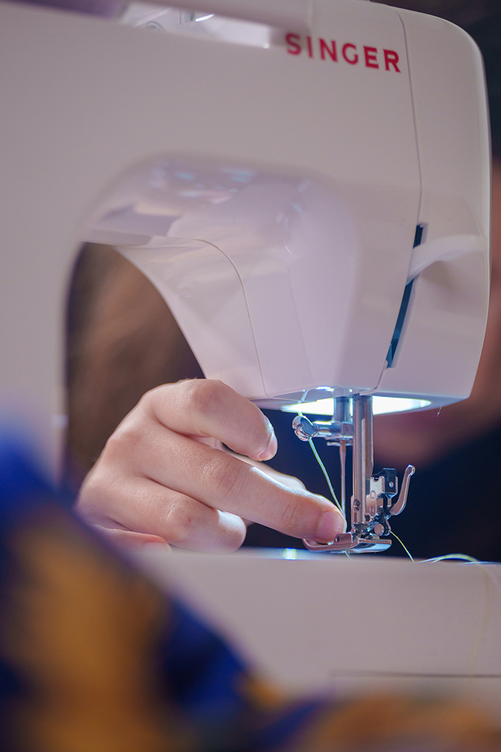 A participant in Bawaajigewin traditional garment making workshop adjusts a sewing machine in Oshawa, Ont., on Oct. 18.