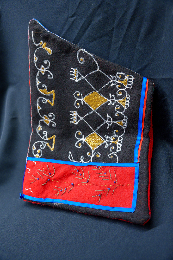 A traditional Mi'kmaq pointed hat with painted embroidery.