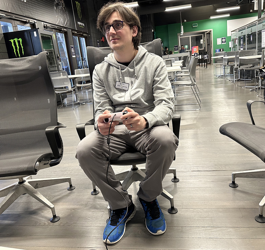 Alex Estrela plays on an Xbox Series S inside the eSports Arena at Durham College.