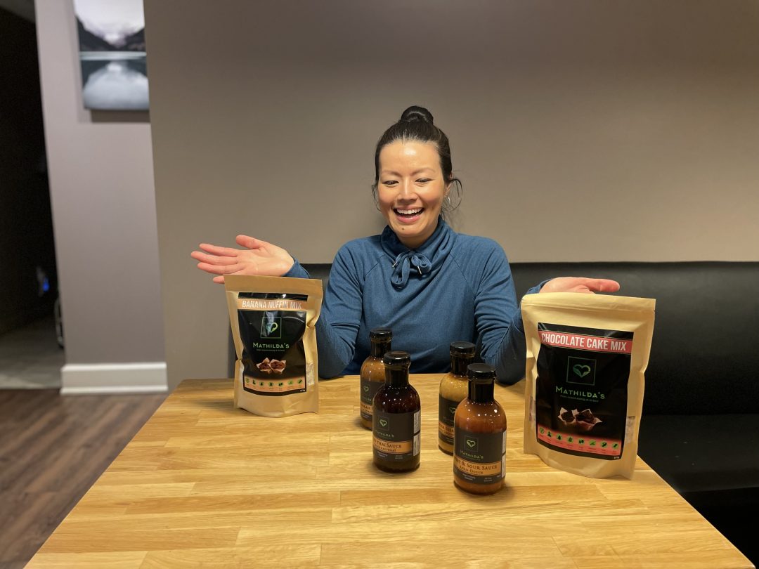 Mathilda Irawan, the owner of Mathilda's, posing with some products from her restaurant.