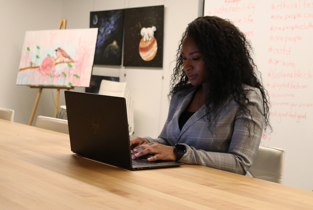 Arna Boothe-bernard types an email into her laptop while connecting with a client for her hair care business in the Fast Start building at Durham College on February 13, 2024.