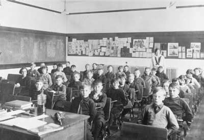 A black and white archival photo of a class of elementary school students from 1930.