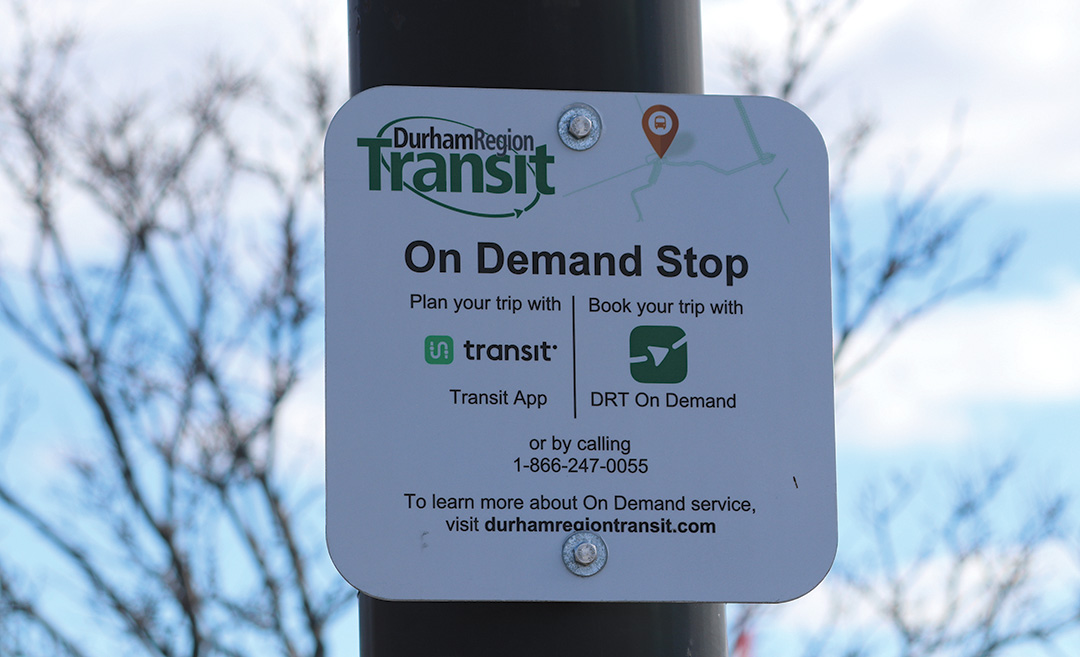 The sign board of DRT's On Demand Stop Service is shown.