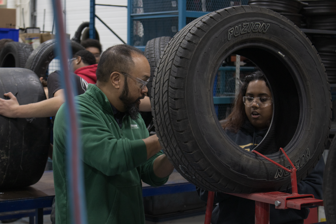 Homer Manlangit working with a student.