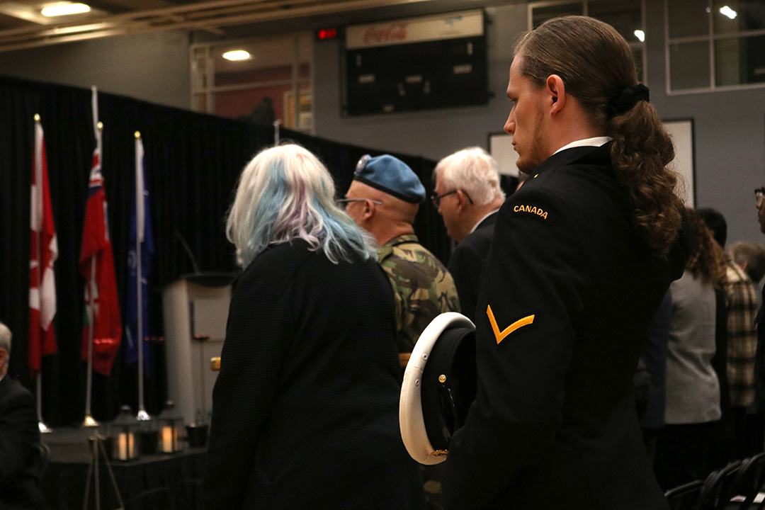 Durham College student Cole MacKinnon observes a moment of silence in his uniform during the Remembrance Day ceremony at the Campus Recreation and Wellness Centre in Oshawa on Nov. 11, 2024.