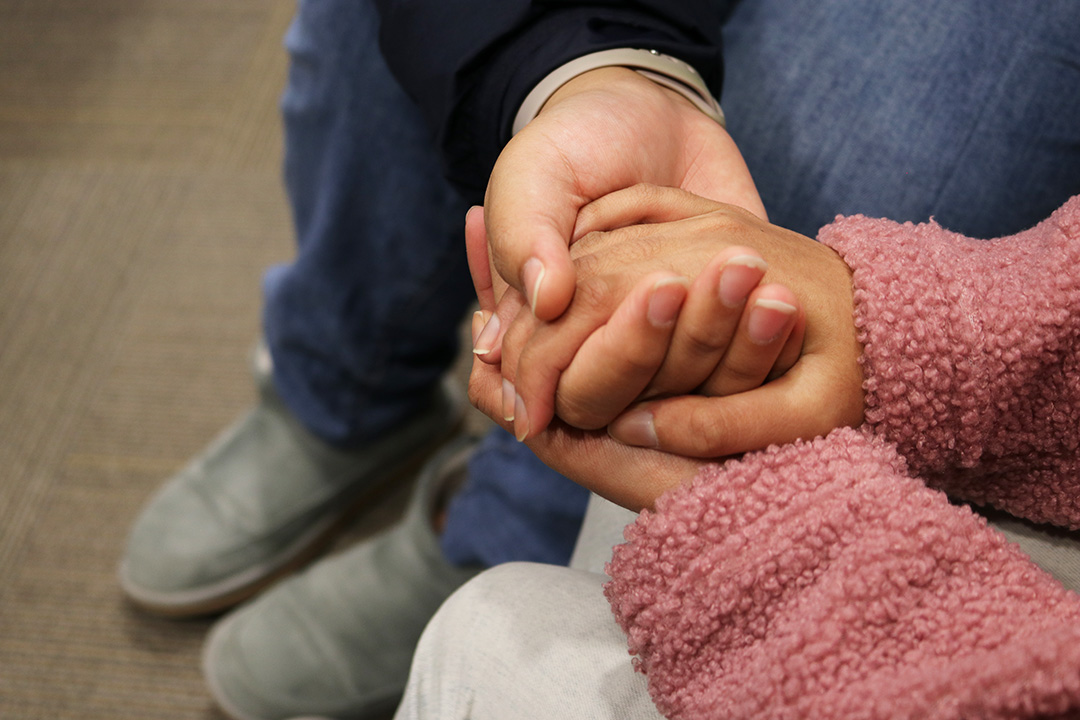 Two Ladies, holding each other's hand.