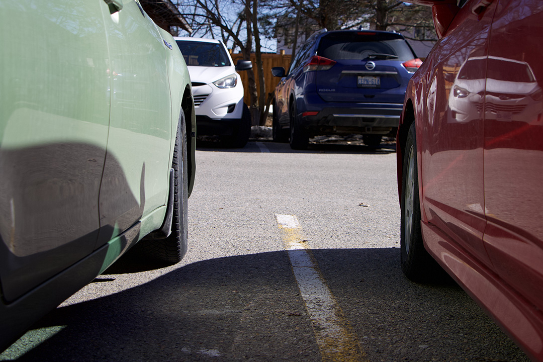 Green car on left and red car on right, white and blue cars in between.