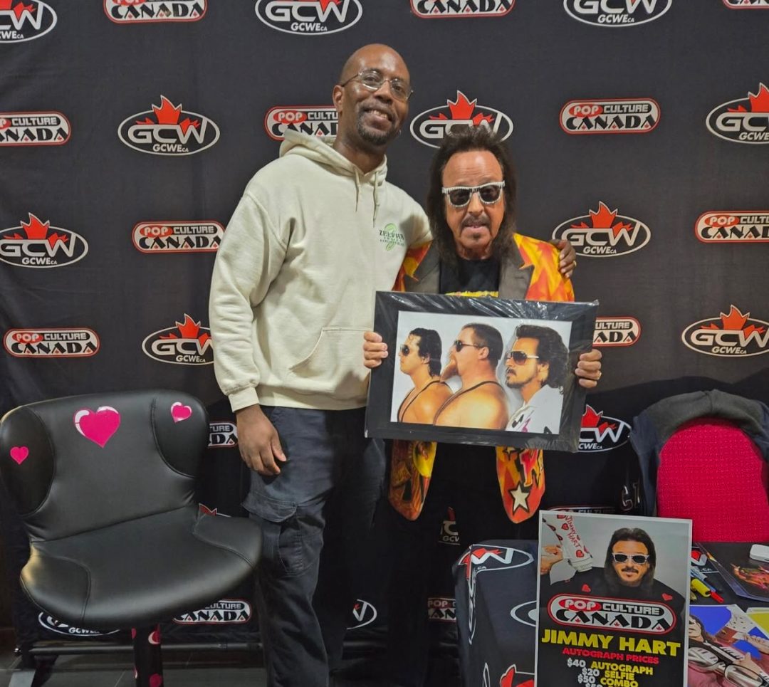 Loue Nuwame; head organizer and social media coordinator of Oshawa ComiCon; shares a moment with WWE legend Jimmy Hart during the event at YWCA Durham in Oshawa on Feb. 22.