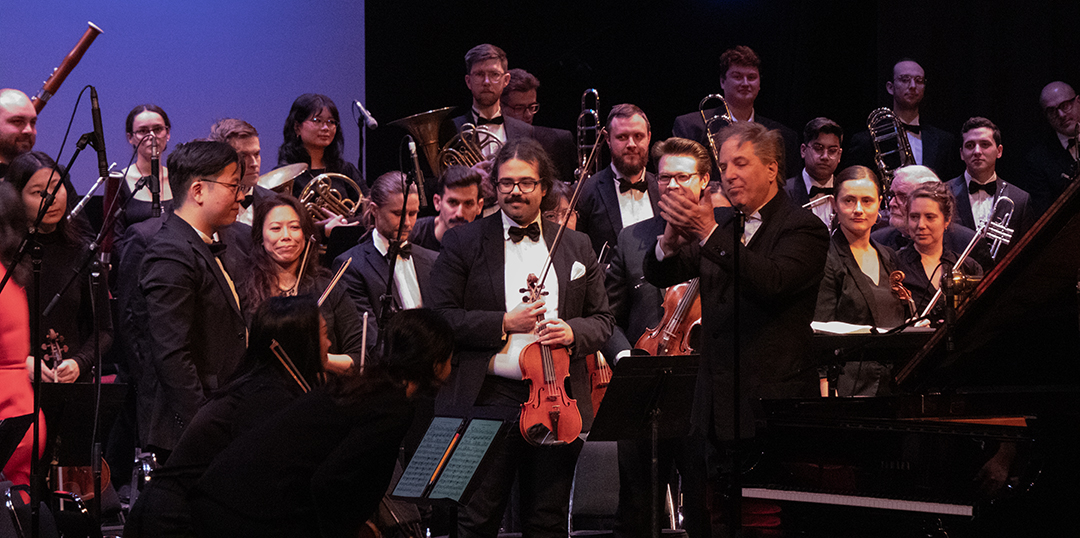 Conductor Marco Parisotto leads the audience in cheering for the orchestra section by section, starting with the violins. This marks the end of the concert in the Regent Theatre in Oshawa, Ont. on Feb. 22, 2025.