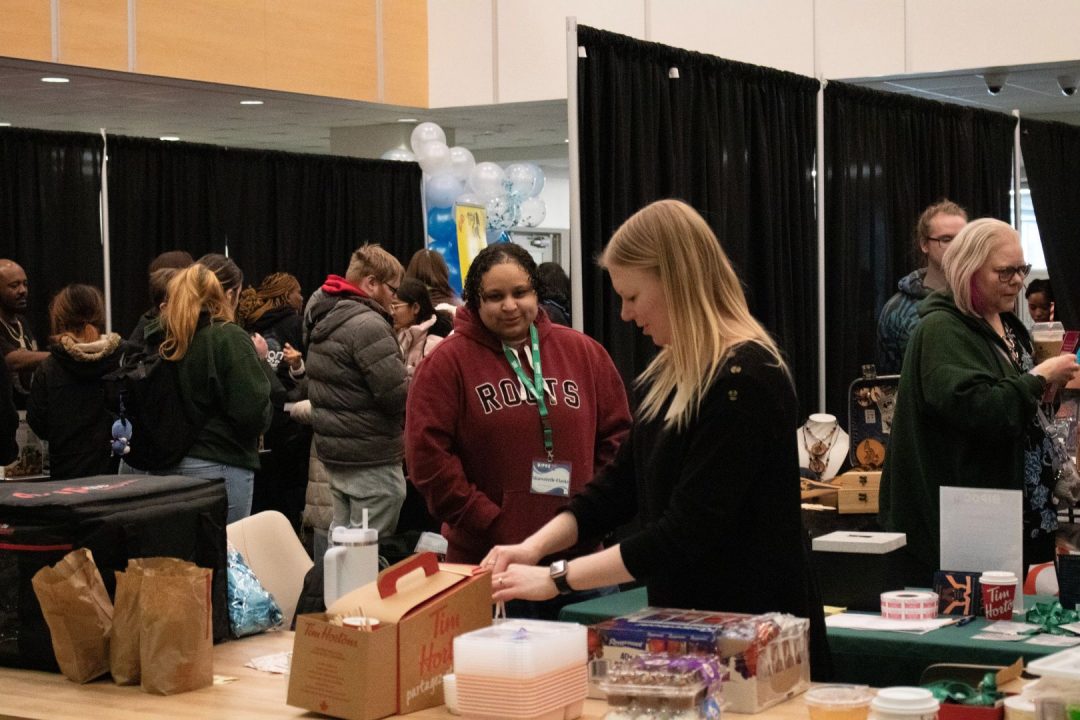 Students and vendors gather at Durham College’s Oshawa campus for the third annual BIPOC Small Business Showcase on Mar. 6, 2025. The event, organized by second-year event planning students, provides a platform for BIPOC entrepreneurs to showcase their businesses, connect with the community, and celebrate cultural diversity. The event featured a diverse lineup of businesses, including smoothie vendors; Indigenous artisans showcasing traditional craftsmanship; an on-site barber; and Korean-inspired artists selling unique accessories and artwork.