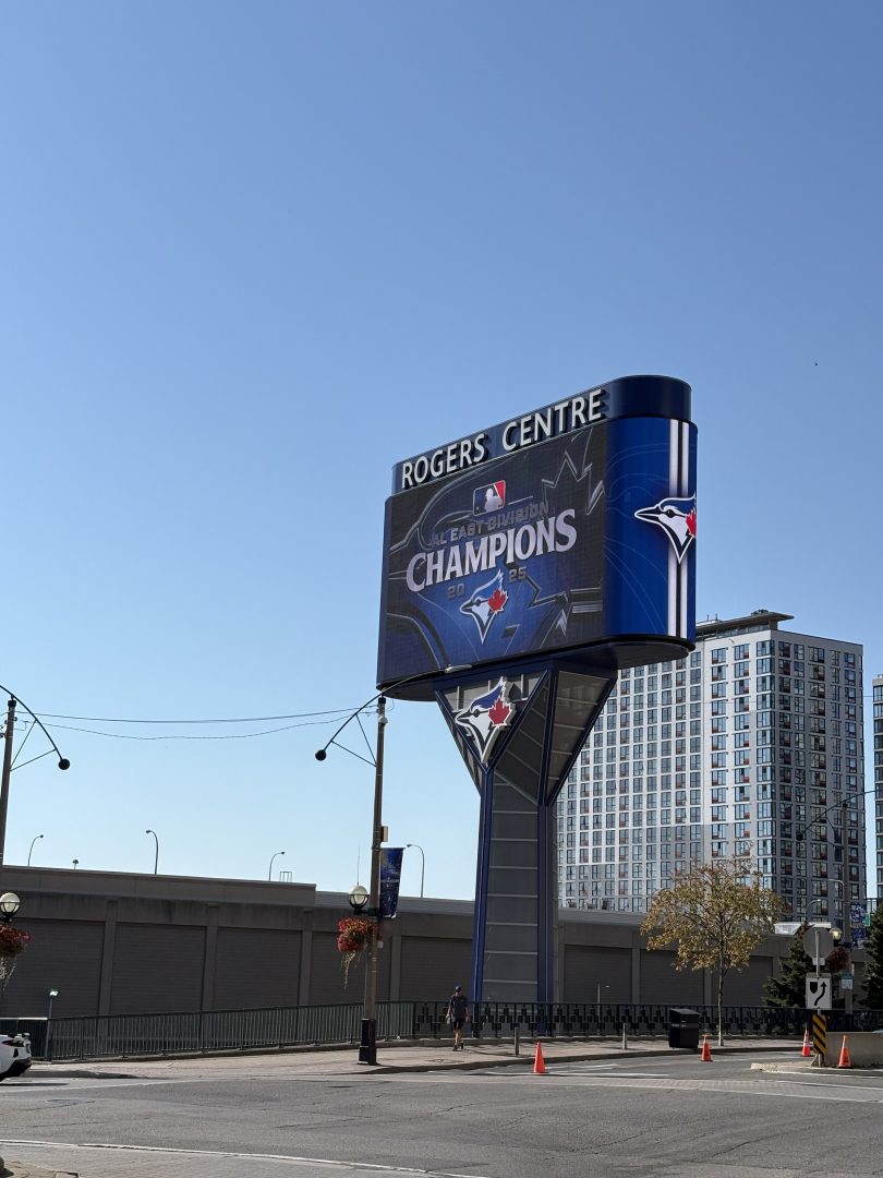 A large digital sign with the words Rogers Centre and Champions, along with a picture of a blue jay and maple leaf.