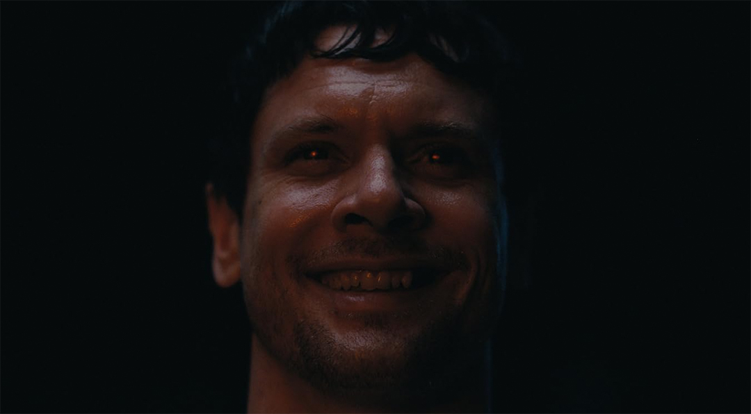 Close up image of the antagonist Remmick portrayed by actor Jack O'Connell.