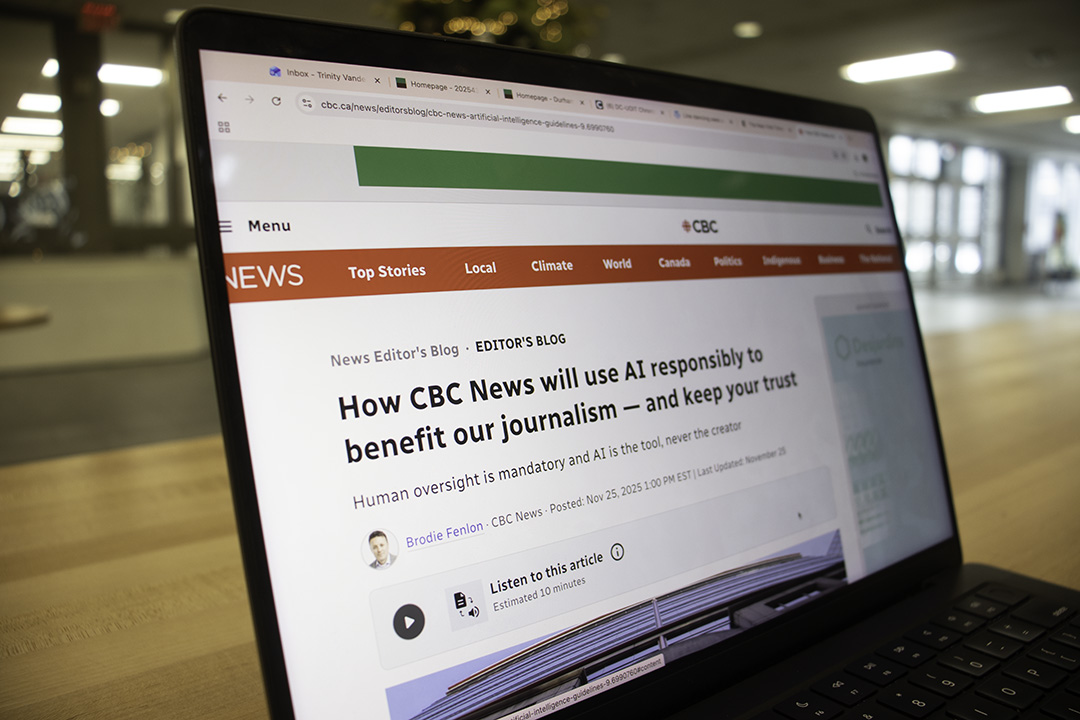 A student reading CBC News’ updated AI Guidelines at Durham College’s Oshawa campus on Dec. 9, 2025.