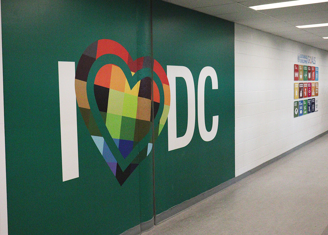 A green and white wall in a hallway with a mural that says 'I heart DC'.