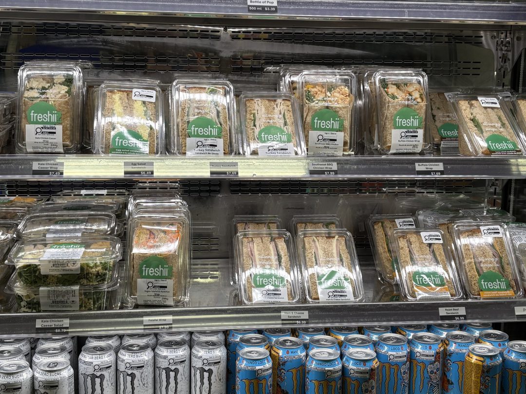A display of sandwiches wrapped in plastic in a college cafeteria