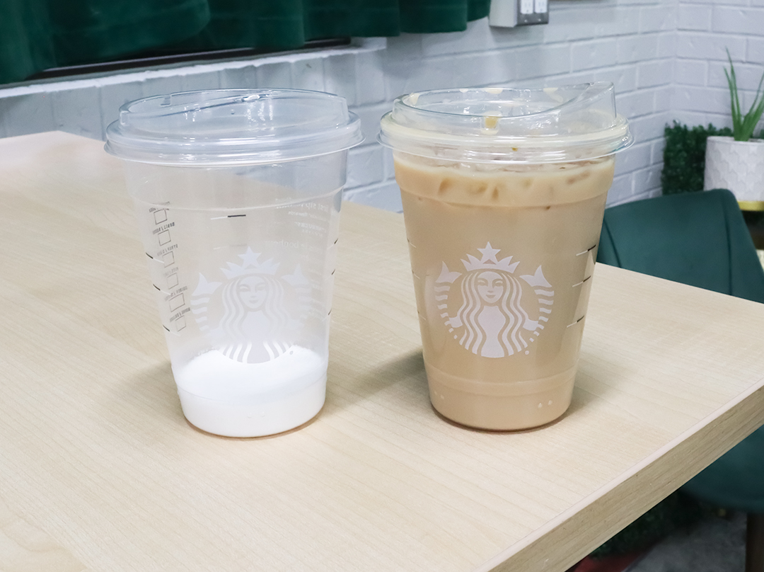 Two plastic cups are standing side-by-side on a wooden table. The cup on the left has eight teaspoons of sugar at the bottom. The cup on the right is filled with coffee.