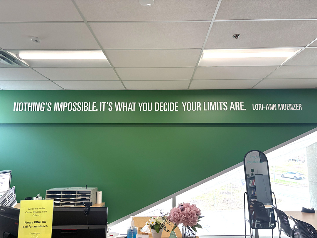 The motto "Nothing&squot;s impossible. It&squot;s what you decide your limits are" is written on a green wall.